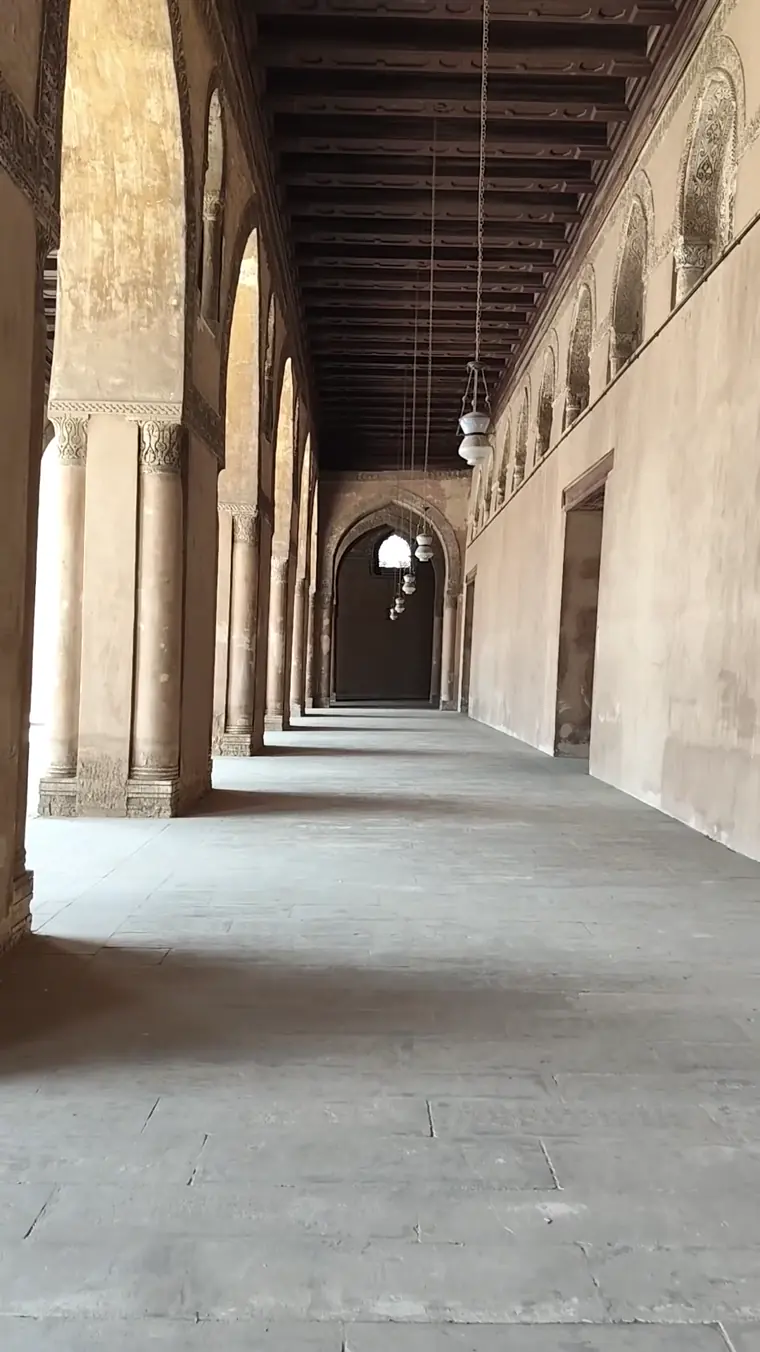 Still frame from Latfi's Cairo video showing a quiet historic arcade